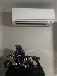 A white mini-split indoor air conditioning unit installed on a gray wall by Calloway & Sons A/C And Heating in New Orleans, LA.