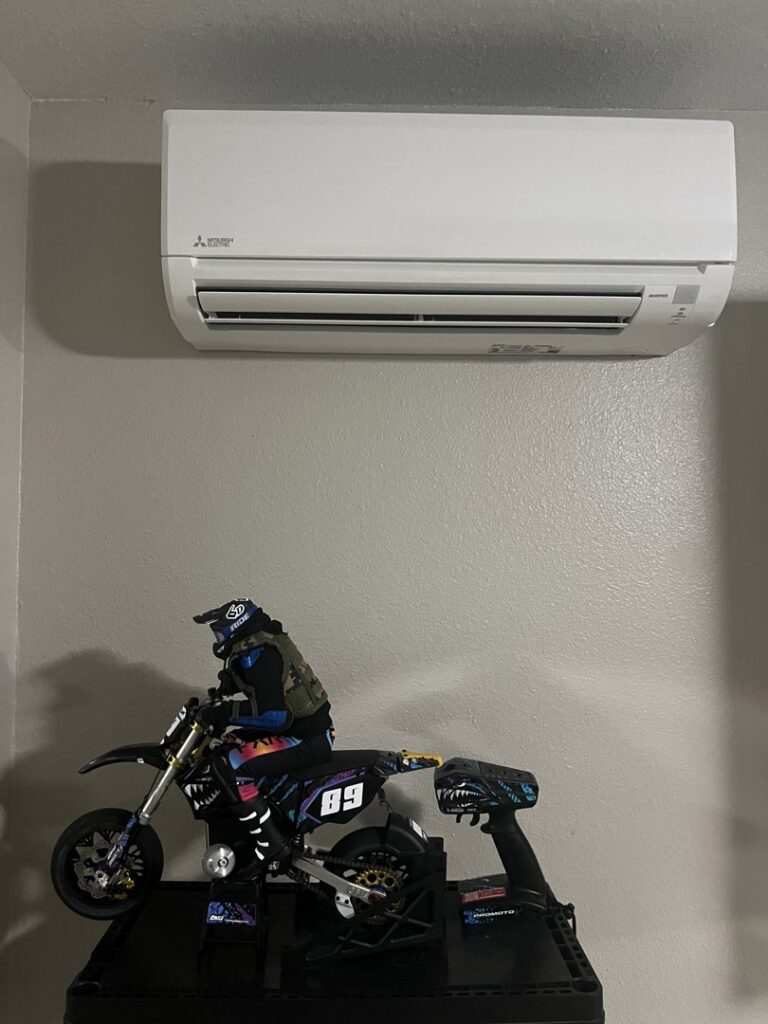 A white mini-split indoor air conditioning unit installed on a gray wall by Calloway & Sons A/C And Heating in New Orleans, LA.