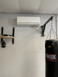 A wall-mounted mini-split indoor unit installed in a gym by Steadfast Mechanical in Gilbert, AZ.