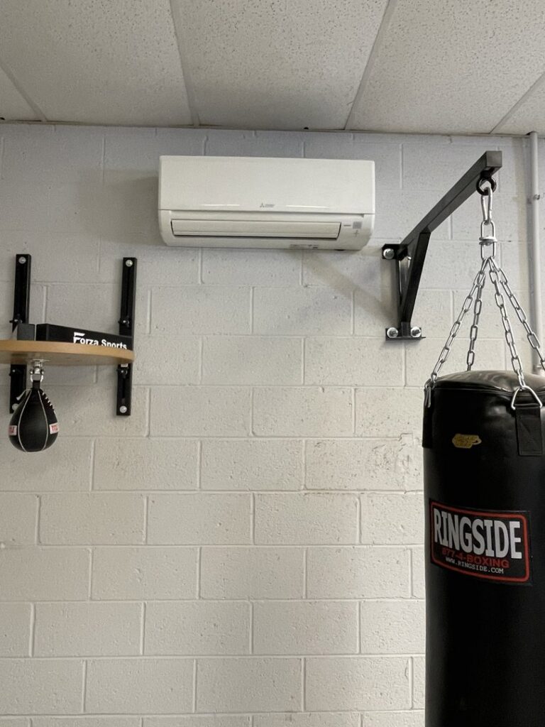 A wall-mounted mini-split indoor unit installed in a gym by Steadfast Mechanical in Gilbert, AZ.