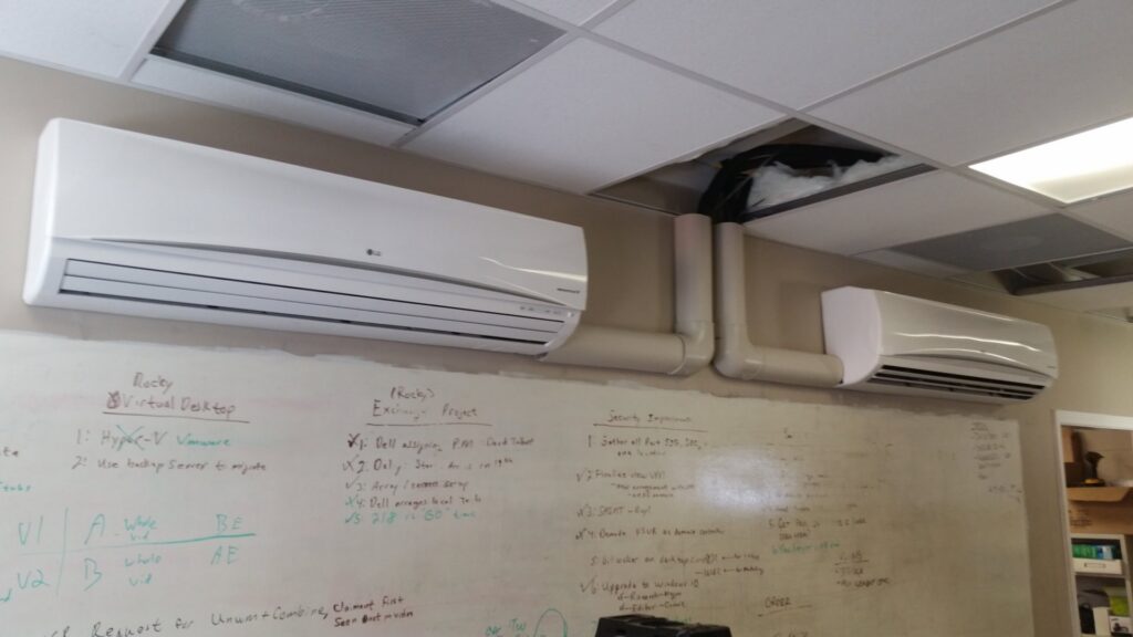 Two mini-split indoor units installed on a wall in an office setting by R&B Cooling&Heating in Abbeville, LA.