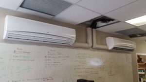 Two mini-split indoor units installed on a wall in an office setting by R&B Cooling&Heating in Abbeville, LA.