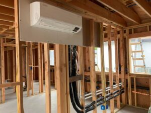 An indoor mini-split unit and exposed HVAC piping during new construction installation by Reliable Heating and Air LLC in Summerville, SC.