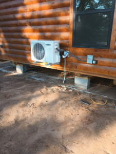Outdoor mini-split condenser unit installed on a wooden building by Air Prime OKC in Oklahoma City, OK