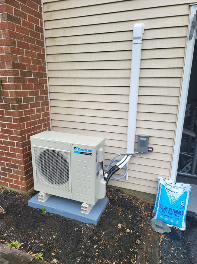 An outdoor mini-split condenser unit installed by Zibi Construction in Mount Prospect, IL.