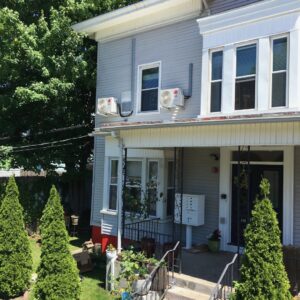 Two LG mini-split outdoor units installed on the exterior of a home by Evergreen Services in Warwick, RI.