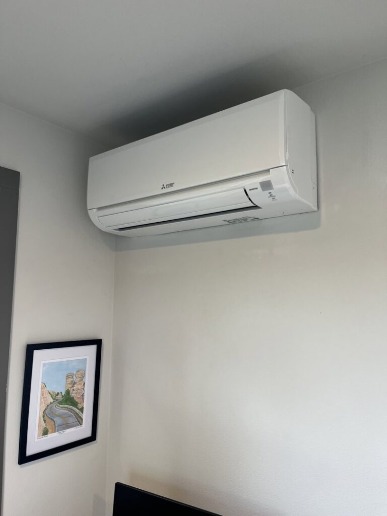 An indoor Mitsubishi Electric ductless mini-split unit installed on a wall by Progressive Comfort Solutions in Seattle, WA.