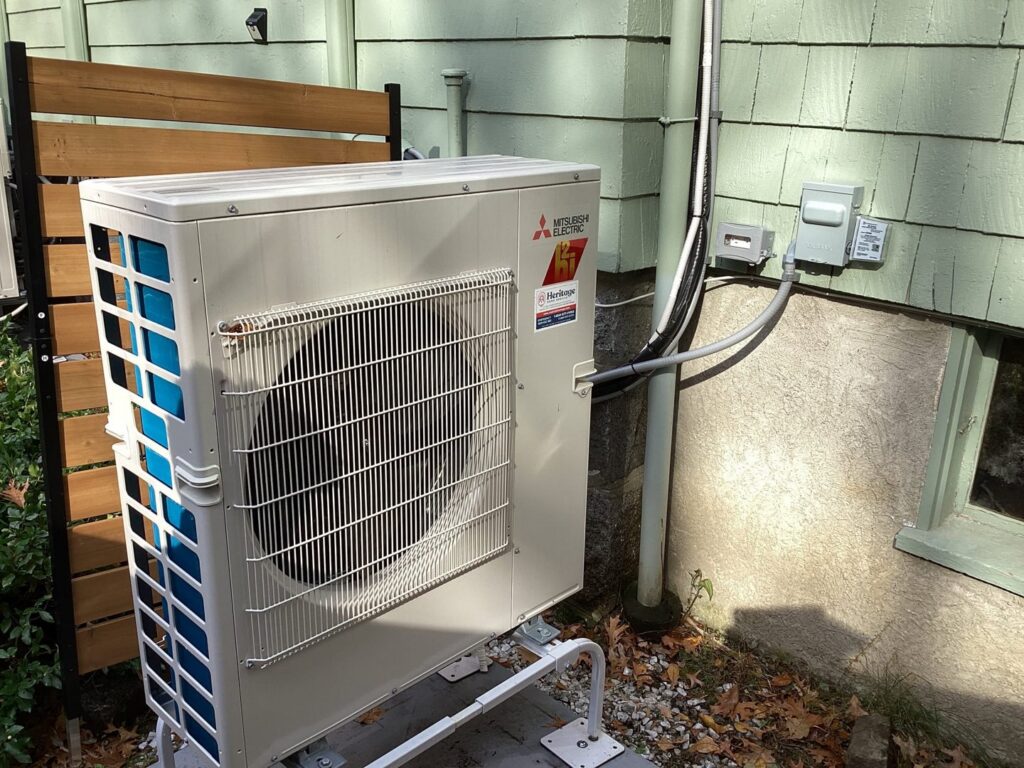 An outdoor Mitsubishi Electric heat pump unit installed by Heritage Home Service in Worcester, MA