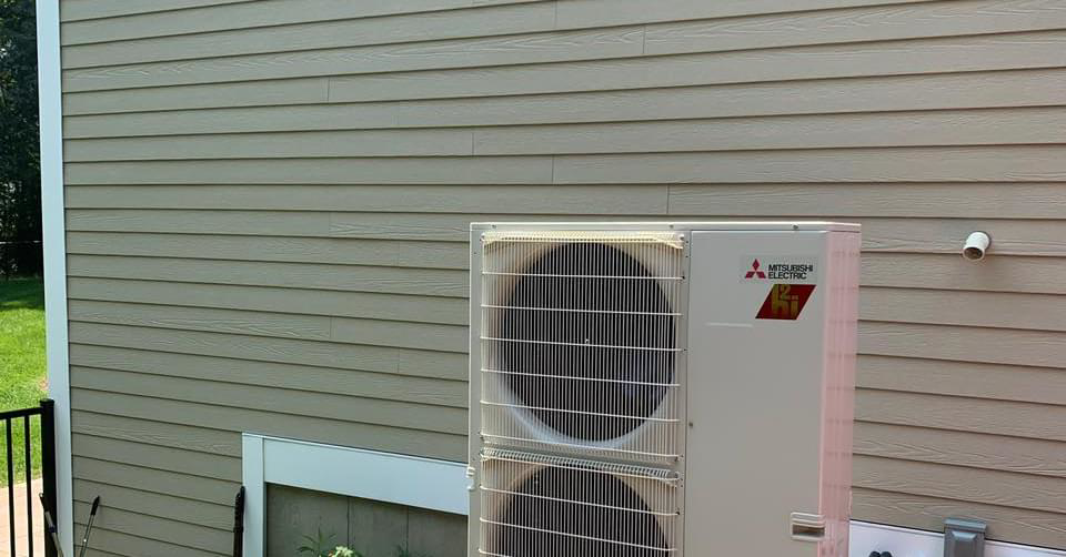 An outdoor Mitsubishi Electric HVAC condenser unit installed by Paul Mechanical LLC in Merrimack, NH