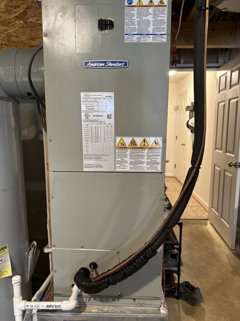 A Mitsubishi Electric mini-split outdoor condenser unit installed in a narrow alleyway by Trusted HVAC in Martinsburg, WV