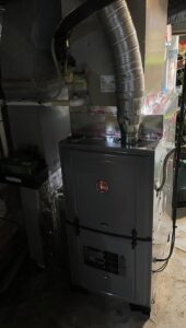 A Mitsubishi Electric mini-split outdoor condenser unit installed on a brick wall by Trusted HVAC in Martinsburg, WV