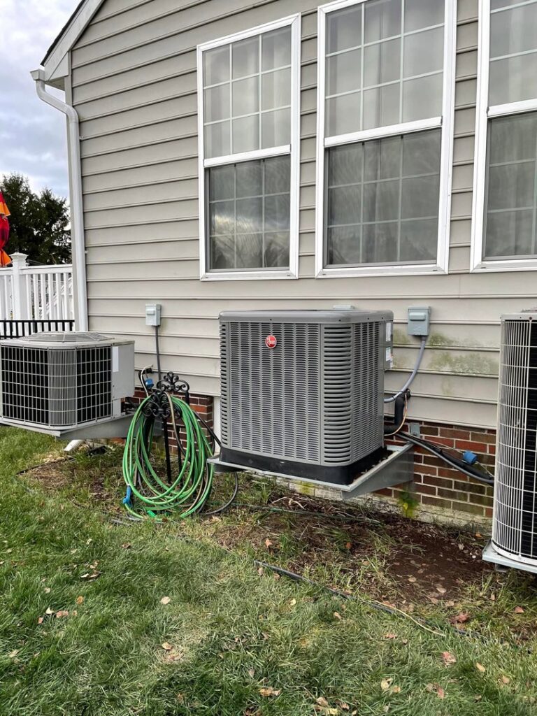 A Mitsubishi Electric mini-split outdoor condenser unit installed on a brick wall by Trusted HVAC in Martinsburg, WV