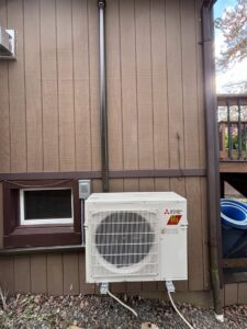 A Mitsubishi Electric mini-split condenser unit installed on the side of a house by KO HVAC Heating & Cooling in Kingston, PA.