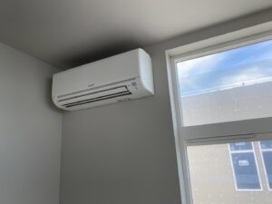 A Mitsubishi Electric mini-split indoor unit installed on a wall in a room by Climate Control Experts HVAC LLC in Federal Way, WA