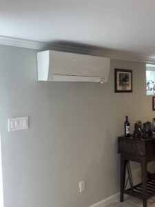 An indoor Mitsubishi Electric mini-split unit installed on a wall by Elite Heating and Cooling in Livonia, MI.