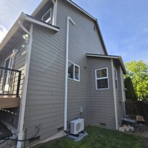 A Mitsubishi Electric mini-split outdoor unit installed on the side of a home by Sound Comfort Heating & Air Conditioning in Everett, WA.