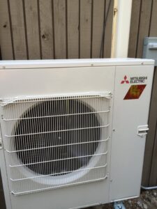An outdoor Mitsubishi Electric mini-split condenser unit installed by Any Climate Mechanical HVAC in Sandy, UT.