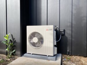 A newly installed Mitsubishi Electric mini-split outdoor unit by Climate Control Experts HVAC LLC in Federal Way, WA