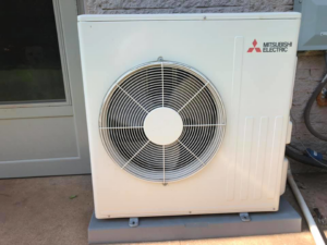 A Mitsubishi Electric mini-split outdoor unit serviced by HVAC Experts, LLC in Edmond, OK.