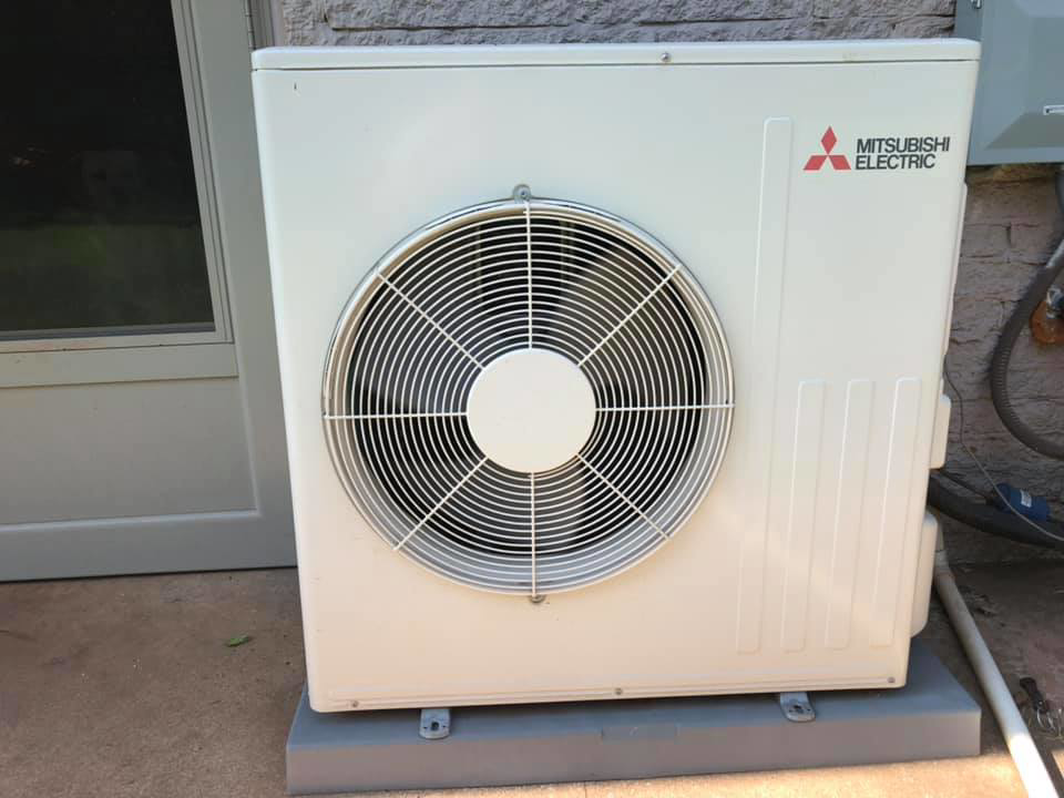 A Mitsubishi Electric mini-split outdoor unit serviced by HVAC Experts, LLC in Edmond, OK.