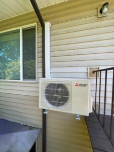 A Mitsubishi Electric mini-split outdoor unit installed on a building wall by Smart HVAC LLC in Vancouver, WA.