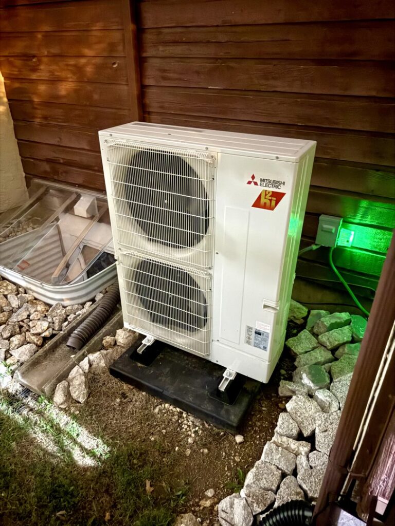 A newly installed Mitsubishi Electric outdoor HVAC unit by Cool y Caliente HVAC Services in Bonner Springs, KS.