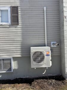 A Mitsubishi Electric outdoor HVAC unit installed on the exterior of a home by KO HVAC Heating & Cooling in Kingston, PA.