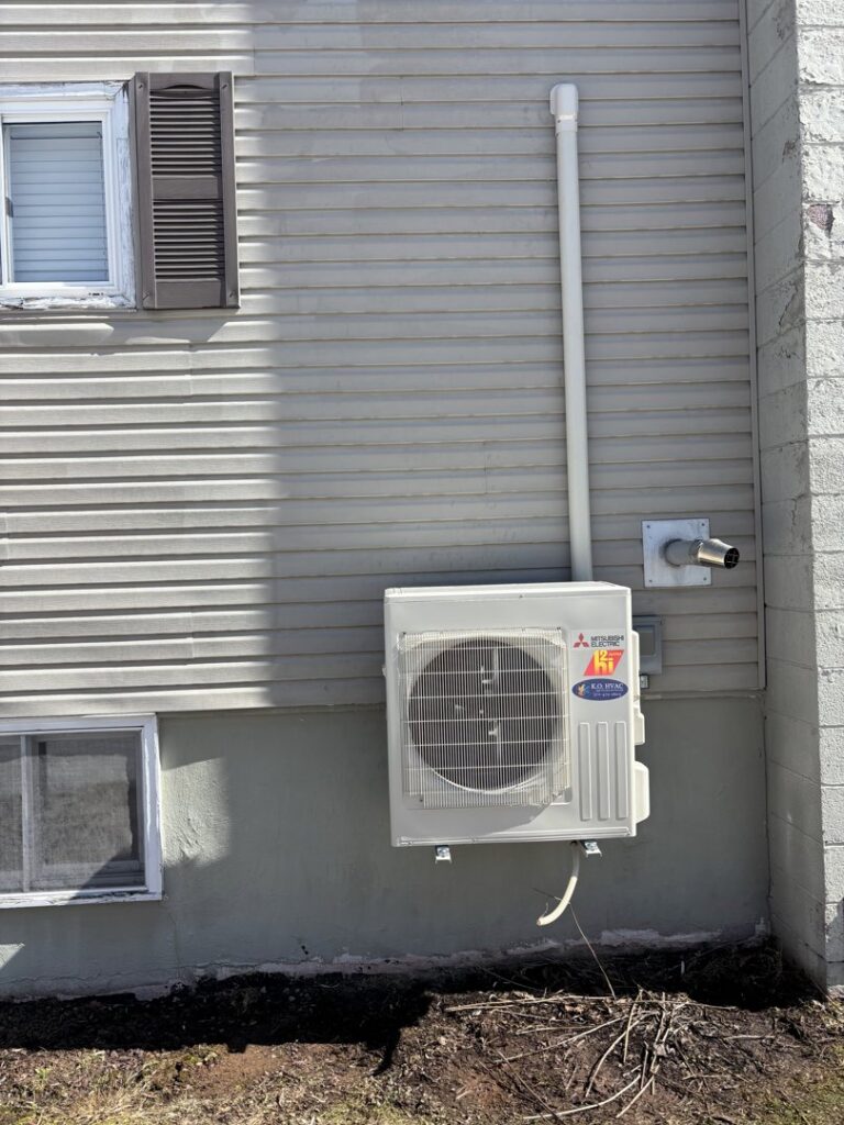 A Mitsubishi Electric outdoor HVAC unit installed on the exterior of a home by KO HVAC Heating & Cooling in Kingston, PA.