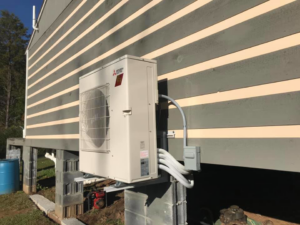 A Mitsubishi Electric outdoor HVAC unit professionally installed on the side of a building by R & R H.V.A.C in Knoxville, TN.