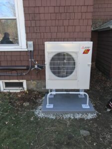 An outdoor Mitsubishi heat pump unit installed by Quality Comfort Inc. in Aston, PA
