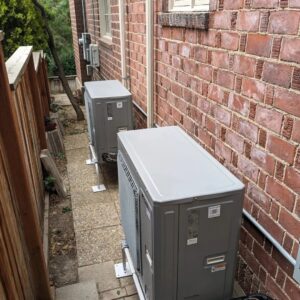 Two Mitsubishi mini-split outdoor condenser units installed by Inspector Rogers LLC in Draper, UT.