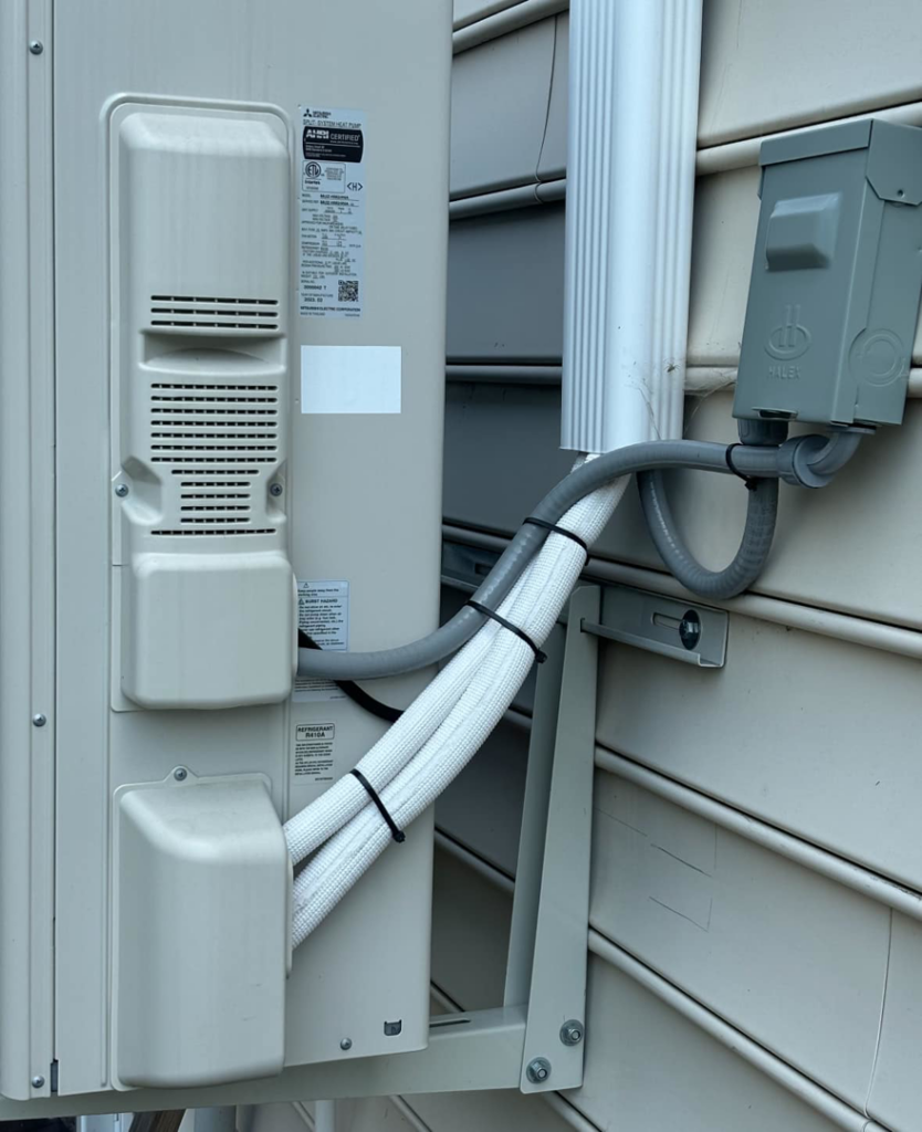 An outdoor Mitsubishi mini-split HVAC unit installed by Greene Mechanical in Holly Springs, GA.