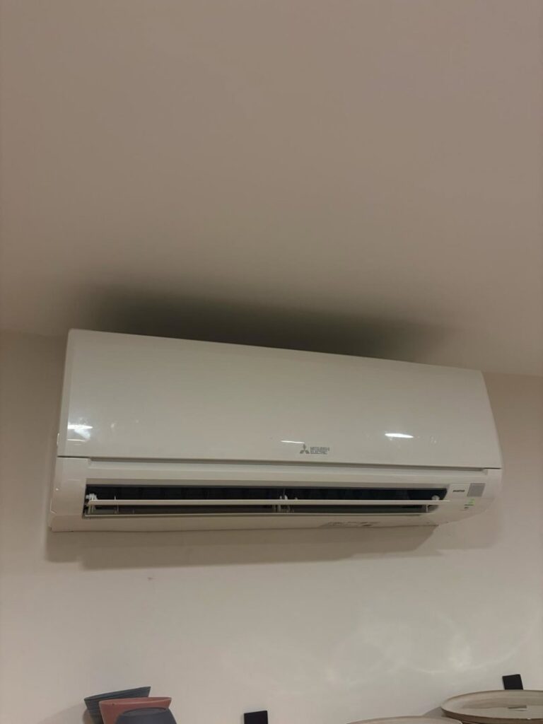 A clean Mitsubishi mini-split indoor unit installed on a wall by Black Oak HVAC in Derry, NH