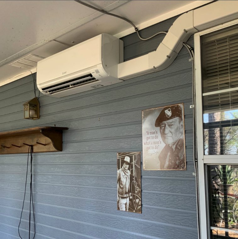 A Mitsubishi mini-split indoor unit installed on a wall with visible line set by Douglas Cooling & Heating in Pelham, AL.