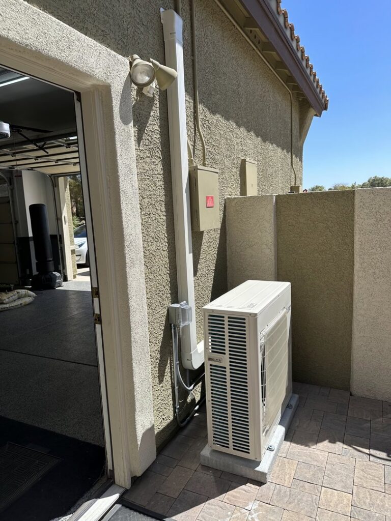 An outdoor Mitsubishi mini-split condenser unit installed by Dakine Heating & Cooling, LLC in Las Vegas, NV.