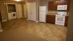 A room featuring a combination of new carpet and tile flooring installed by Keystone Carpet & Tile in Omaha, NE.
