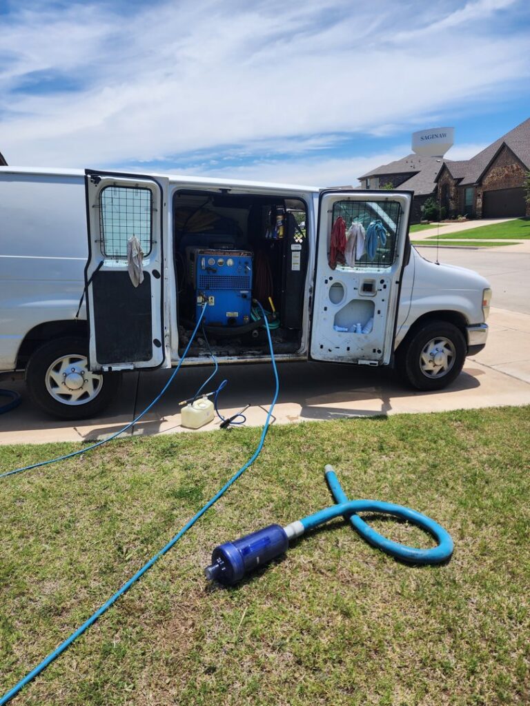 A Carpet Care Express service van with hoses extended, ready for mobile carpet cleaning at a residence in Garland, TX