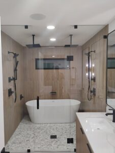 A modern bathroom featuring recessed lighting and illuminated mirrors, showcasing electrical installation by Envision Electrical Solutions in Fort Lauderdale, FL.