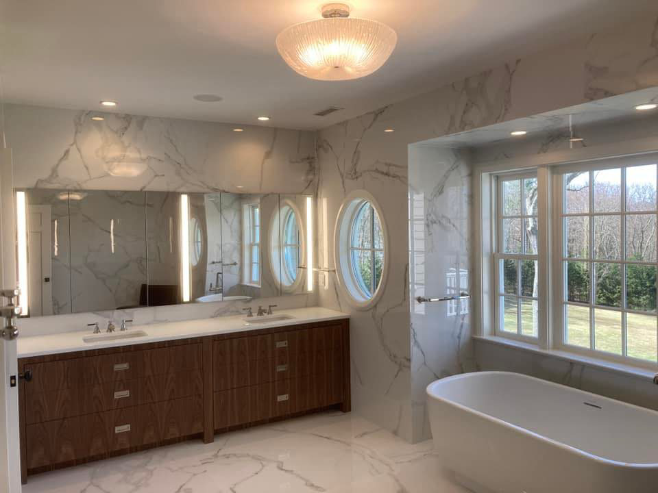 Modern bathroom with new recessed lighting, vanity lights, and a stylish ceiling fixture installed by Golden Electric in Danbury, CT.