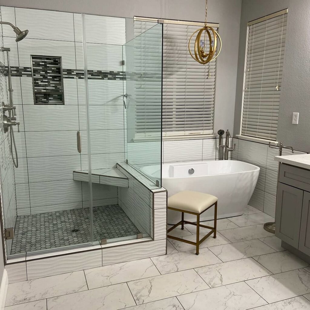 Modern bathroom with walk-in shower, freestanding tub, and white tile flooring by Sulcas Carpets & more in Elk Grove, CA