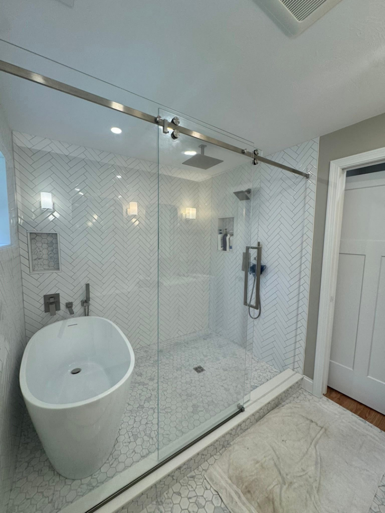 Modern bathroom featuring stylish wall sconces and recessed lighting installed by P. Cruz Electric LLC in Springfield, MA.