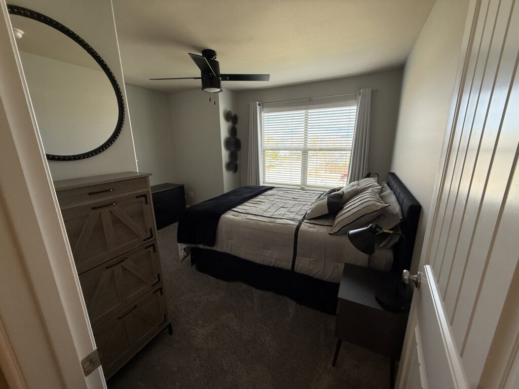 A modern bedroom featuring new carpet installation by Pierce Carpet Mill Outlet in Bozeman, MT.
