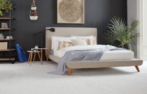A modern bedroom featuring a soft, light-colored carpet installation by Wall To Wall Carpet One Floor & Home in Eau Claire, WI