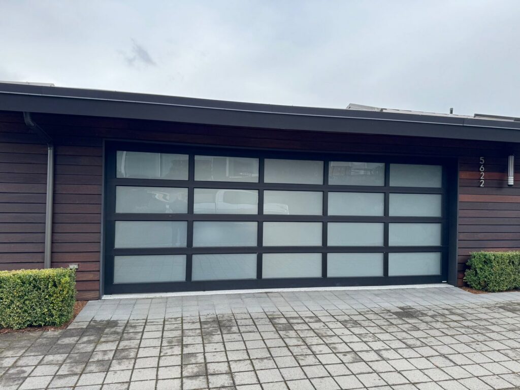 Modern black garage door with frosted glass panels installed by AAA Garage Door Services in Renton, WA