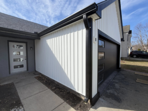 Exterior view of a modern black garage door with windows installed by 365 Construction Group in Indianapolis, IN.