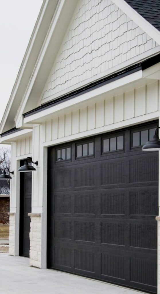 A newly installed modern black garage door on a residential home by Absolute Garage Doors LLC AZ in Mesa, AZ