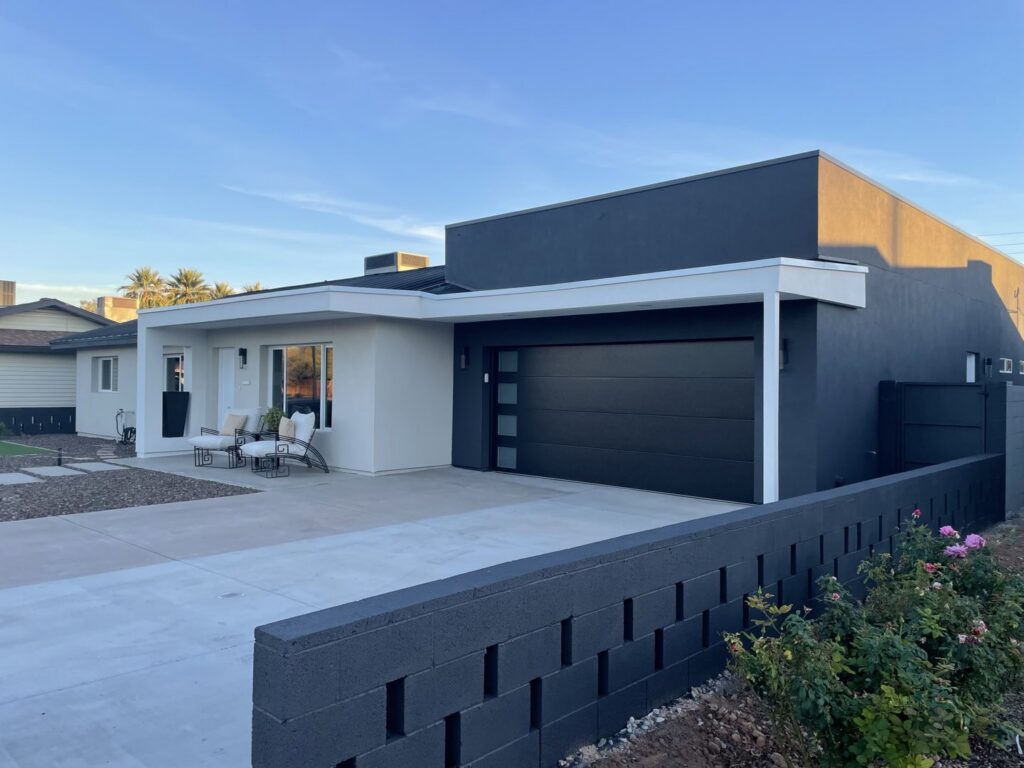 A sleek modern black garage door installed on a contemporary home by Morning Star Garage Doors in Phoenix, AZ.