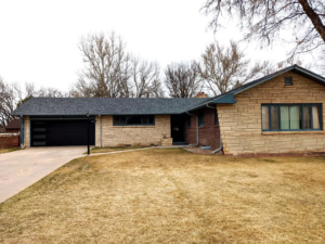 Modern black garage door with horizontal windows installed by Southern Colorado Garage Door in Pueblo, CO.