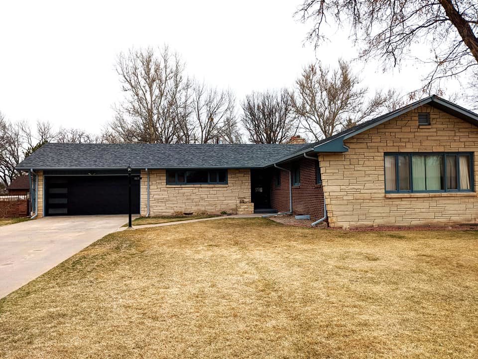 Modern black garage door with horizontal windows installed by Southern Colorado Garage Door in Pueblo, CO.