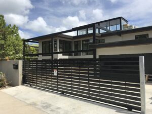 A modern black horizontal slat sliding gate installed for a residential property by A&D Services in Kapolei, HI.
